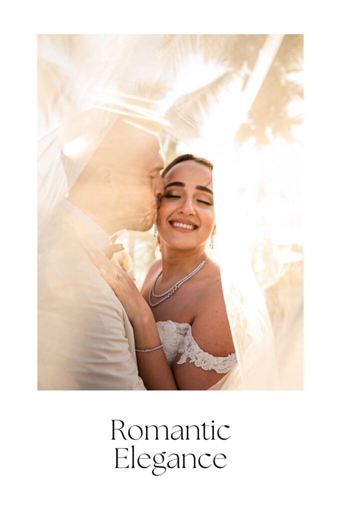 Groom kissing bride beneath veil, golden light in Cancún