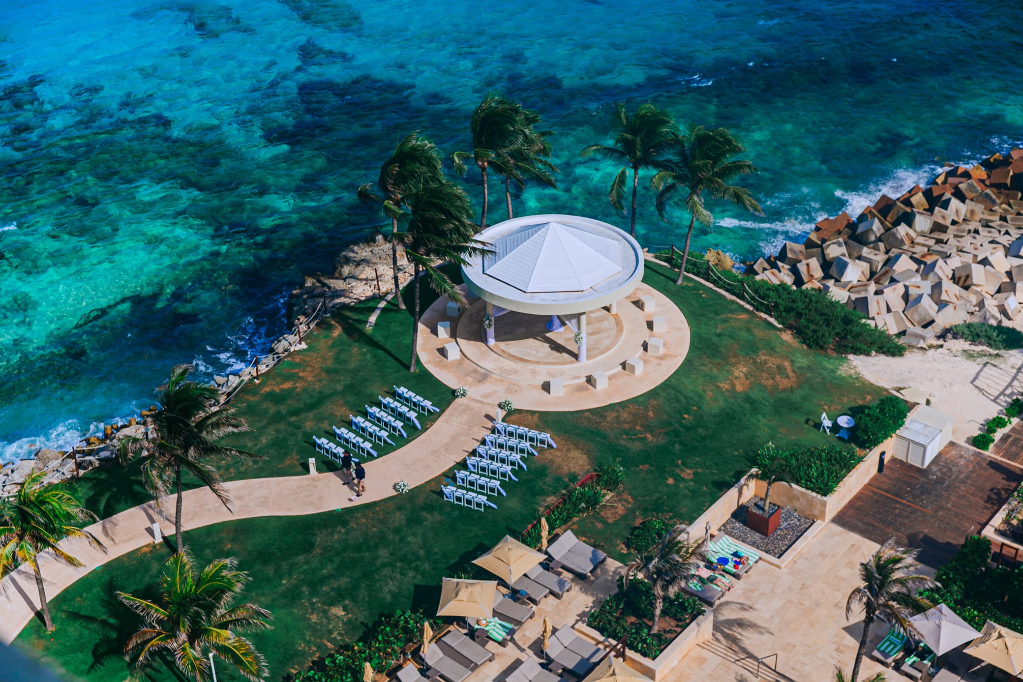 Aerial view of a luxury oceanfront private villa with a round wedding pavilion in Cancun, Mexico