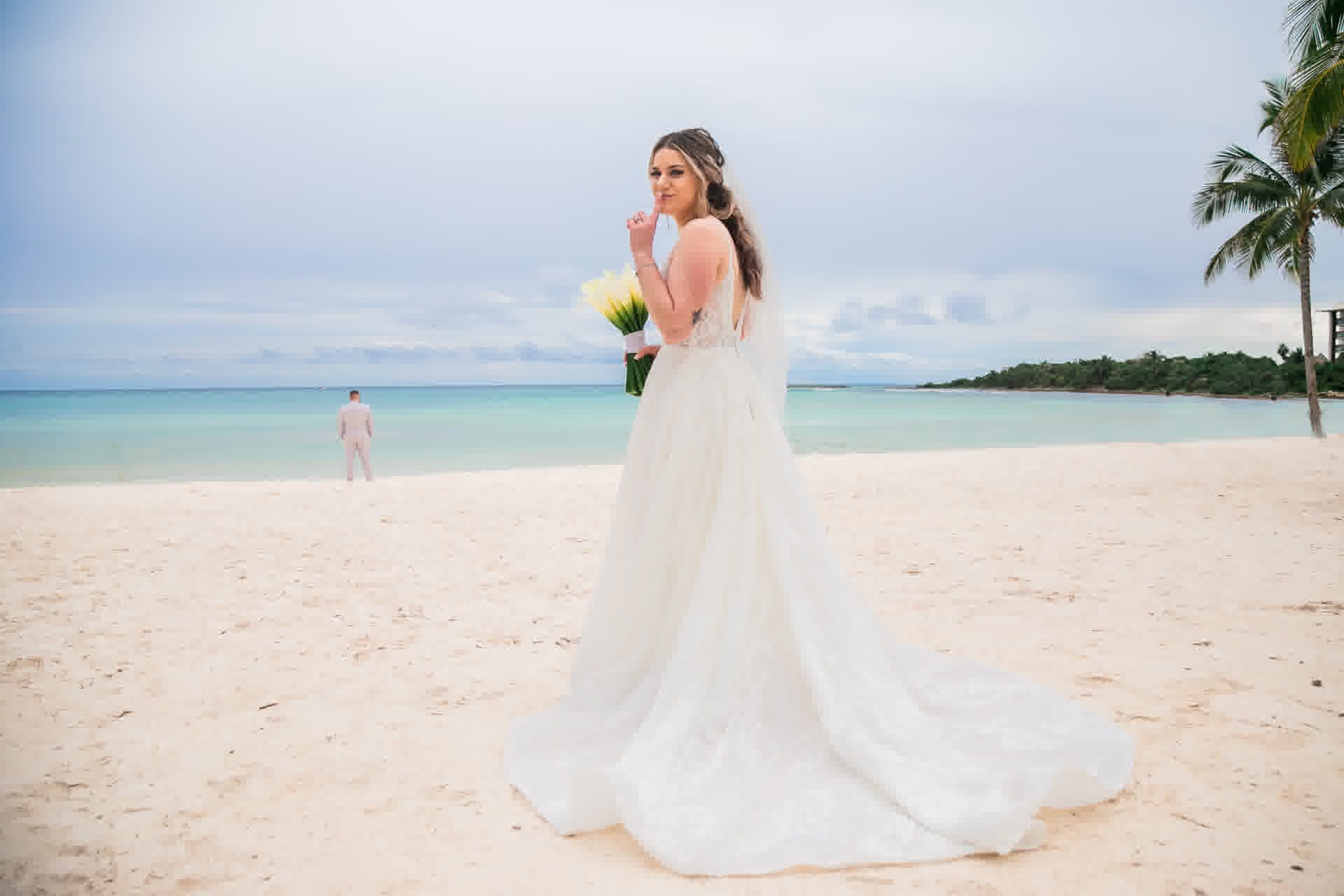 Bride on a quiet Cancun beach during an intimate destination wedding photographed by Xavier Bau Weddings