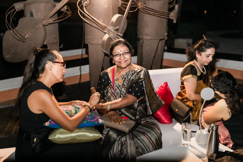 Guest receiving henna during a South Asian destination Mehndi celebration photographed by Xavier Bau Weddings