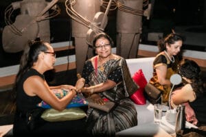 Guest receiving henna during a South Asian destination Mehndi celebration photographed by Xavier Bau Weddings