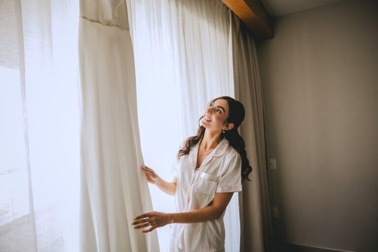 Kishory beside a sunlit window while getting ready at Dreams Natura.