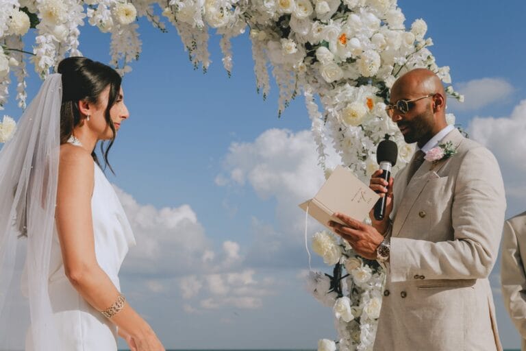 Kyle reading his vows to Kishory beside the sea in the Riviera Maya.