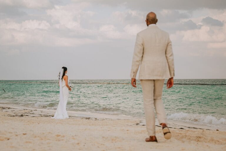 Kyle walking toward Kishory at the edge of the sea.
