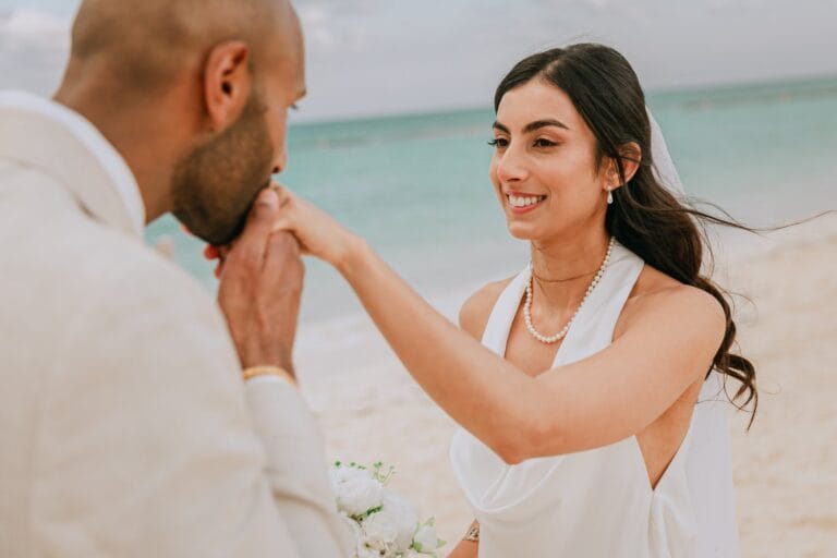 Kyle kissing Kishory’s hand during their beach portraits.