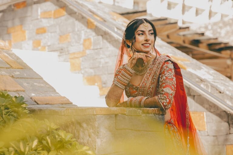 A closer portrait of Kishory and her bridal jewelry beside the stone staircase.