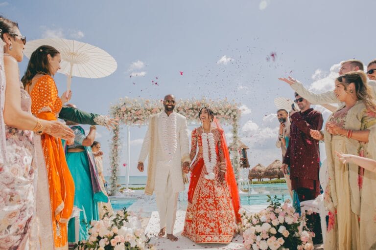 Kyle and Kishory leaving the ceremony as guests shower them with petals.