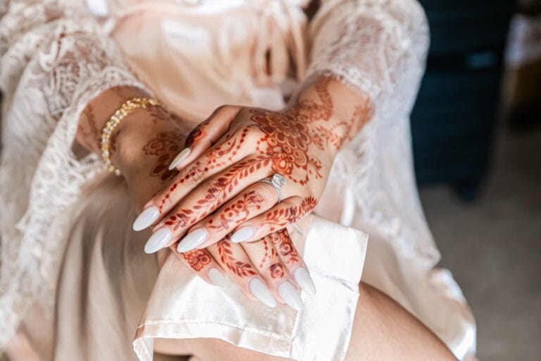 Close-up of Nusaibah's henna-decorated hands during wedding preparations at Barcelo Riviera Maya.