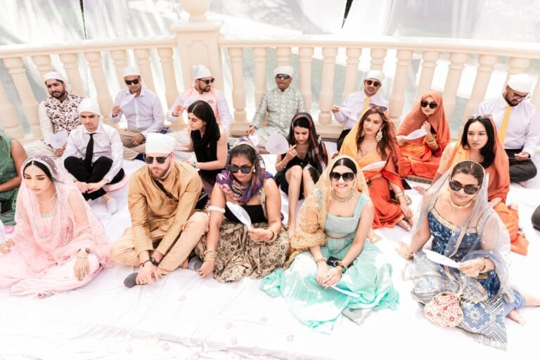 Wedding guests seated together at the outdoor Sikh ceremony at Barcelo Riviera Maya.