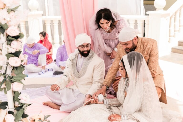 Nusaibah and Jai sharing a smiling moment with guests during the ceremony at Barcelo Riviera Maya.