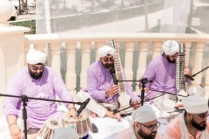 Three musicians performing beside the outdoor wedding ceremony at Barcelo Riviera Maya.