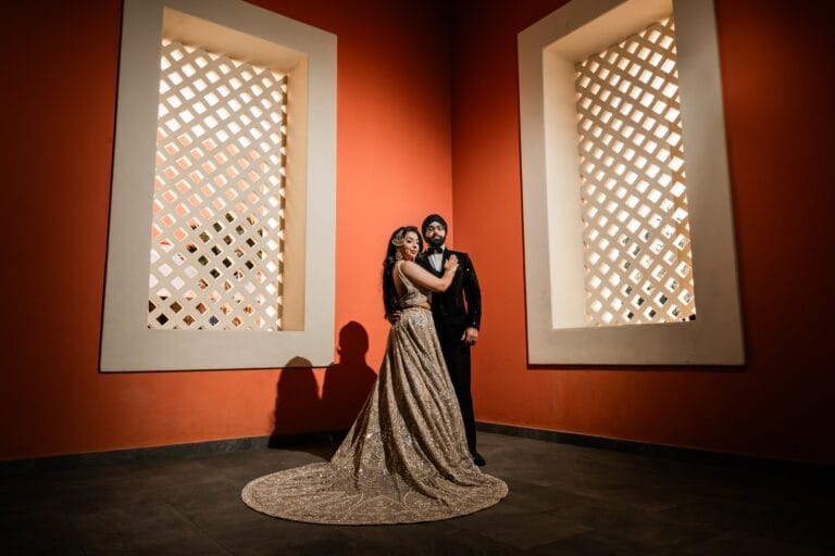 Nusaibah and Jai embracing beside sunlit lattice windows at Barcelo Riviera Maya.