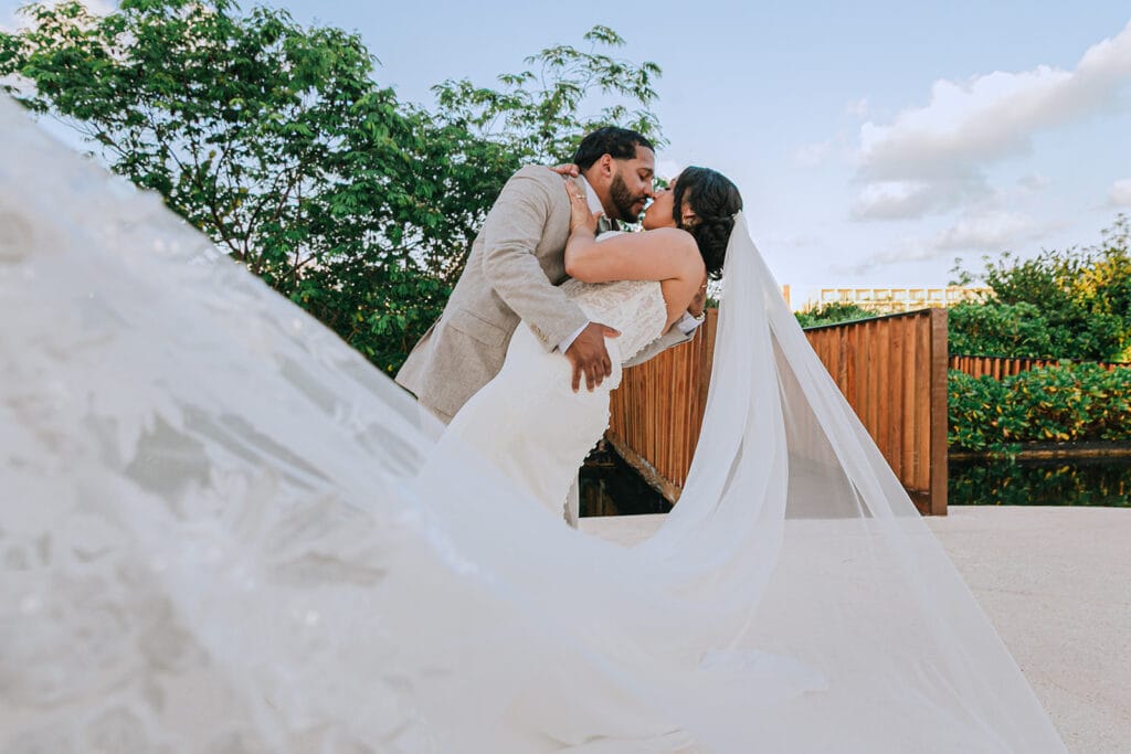 Victoria and Jose kissing with her veil extending across the foreground
